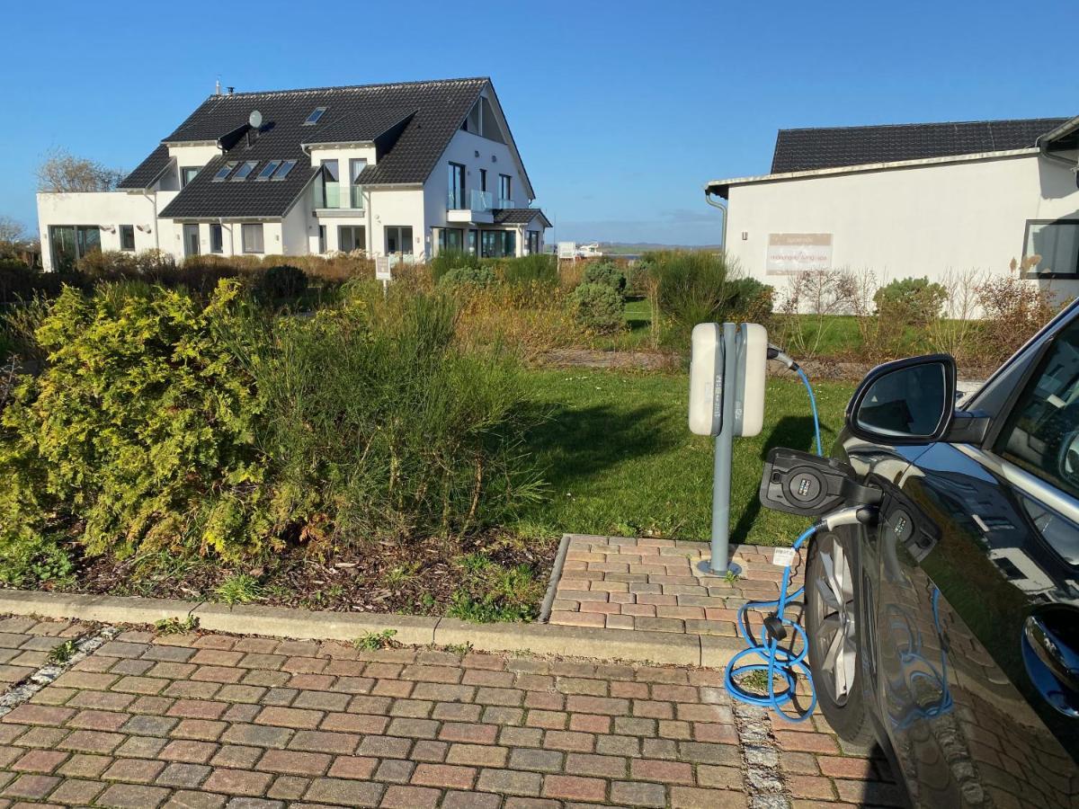 Moenchgut Living & Spa Gager Eksteriør billede A car is charged at a charging station in Germany
